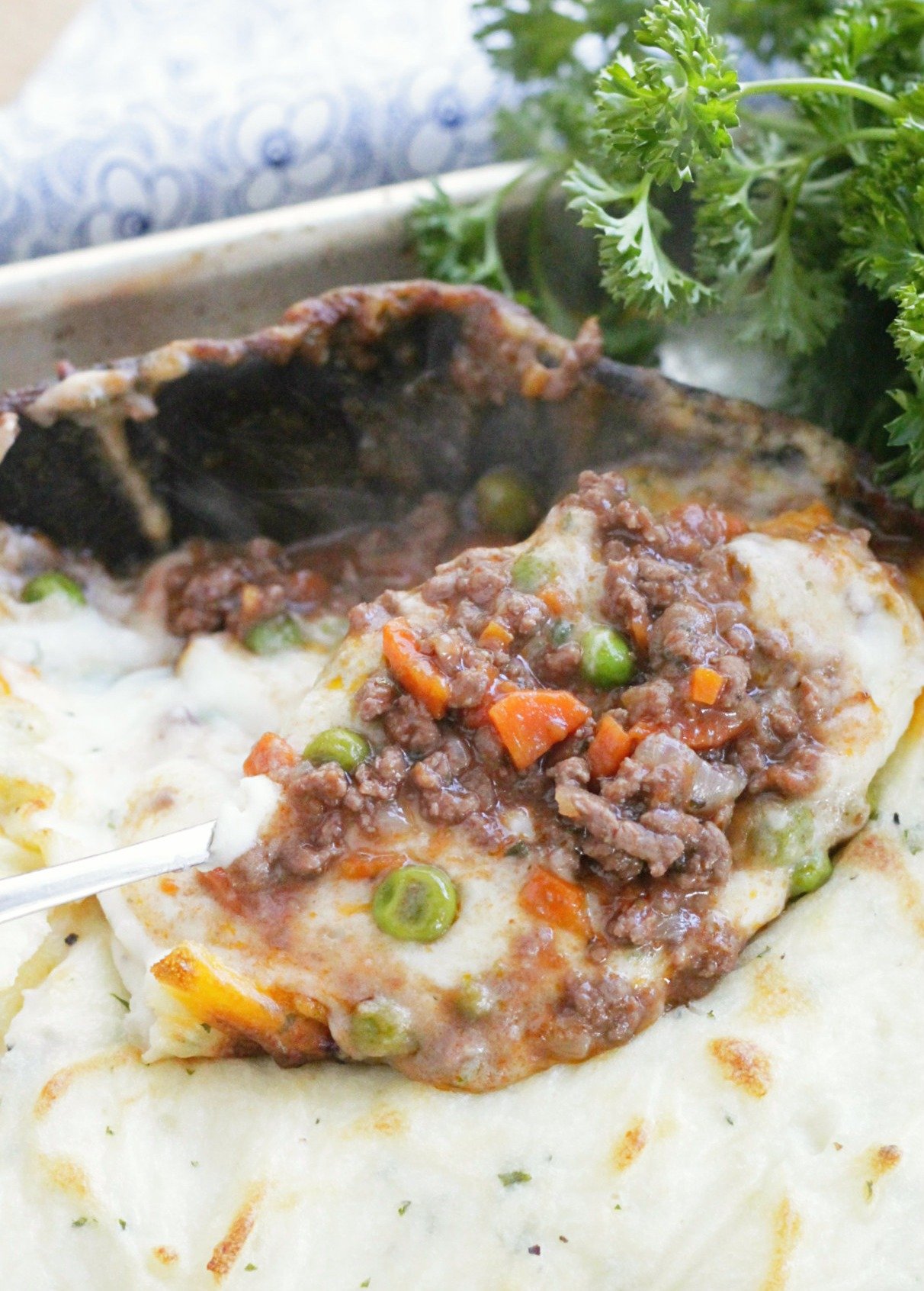 showing the beef and gravy filling underneath the mashed potato topping of the skillet shepherd's pie