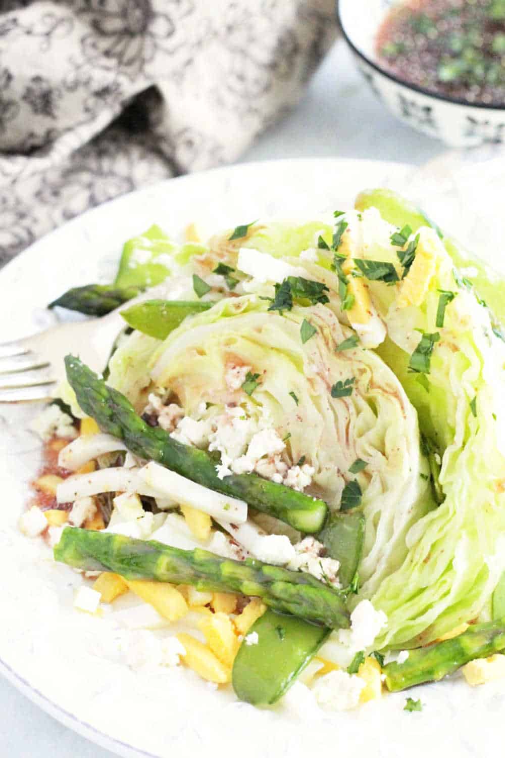 A classic wedge salad gets a fresh make-over for the warmer months as this Spring Wedge Salad with asparagus, snap peas and a red wine vinaigrette dressing. via @foodtasticmom