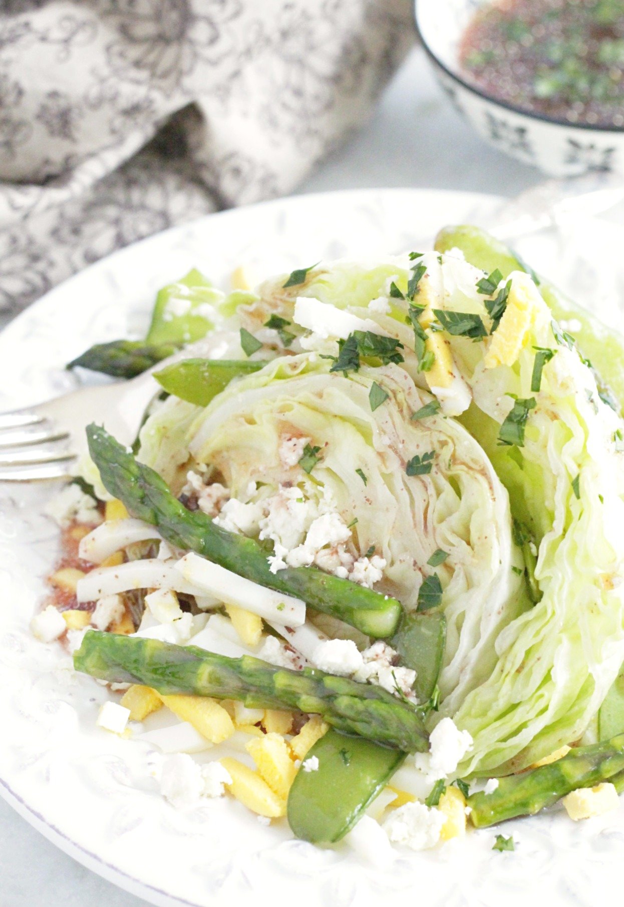 plated spring wedge salad featuring asparagus