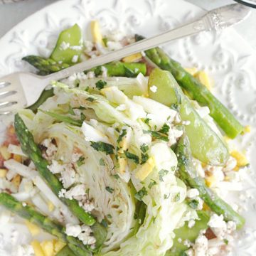 top view of spring wedge salad on plate with fork