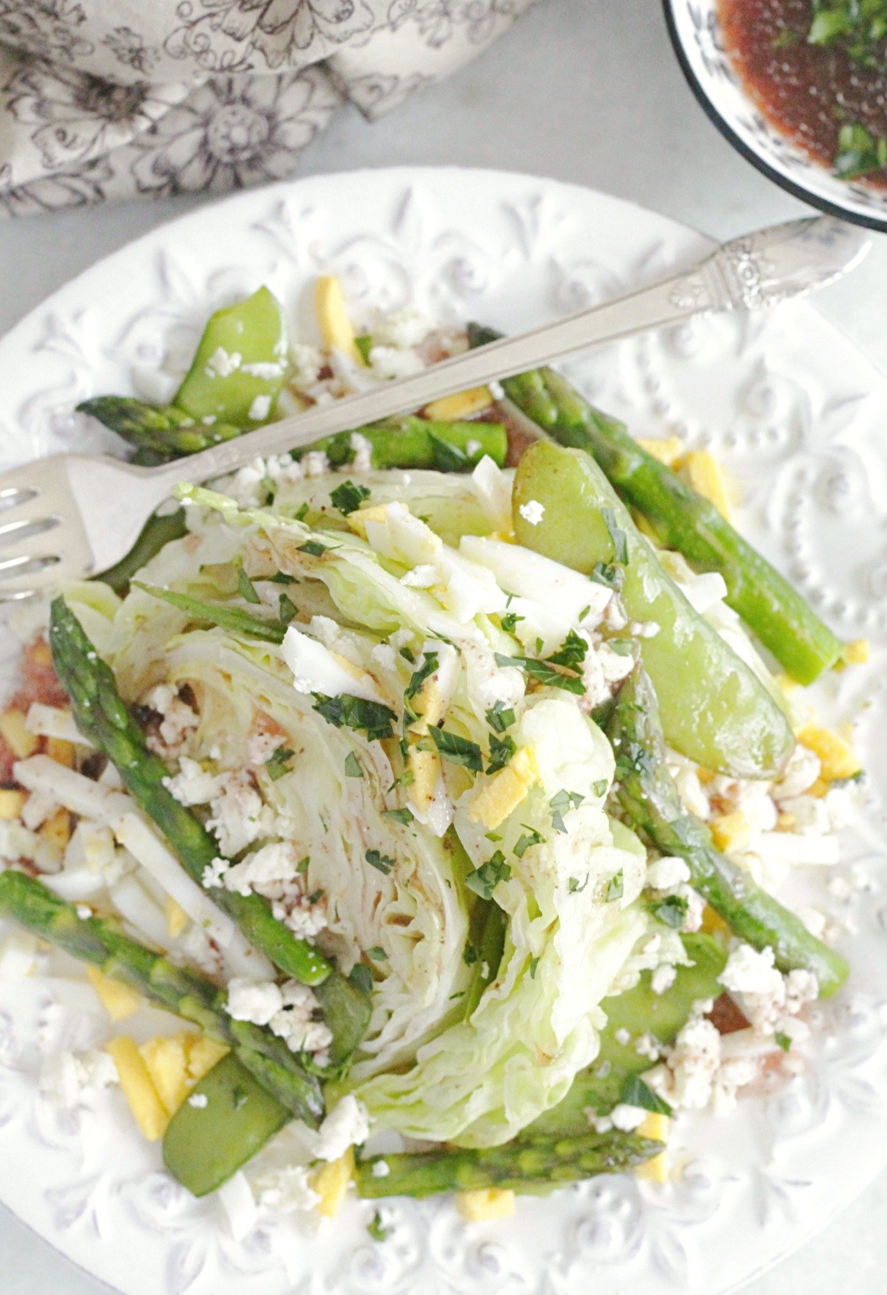 top view of spring wedge salad on plate with fork
