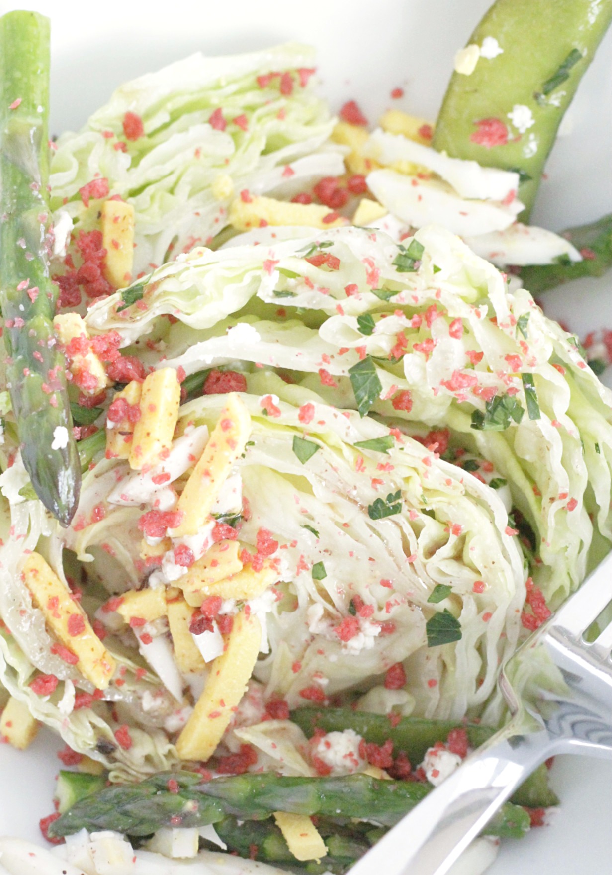 spring wedge salad in a bowl topped with bacon bits