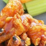 close up of crispy baked chicken wings showing off the buffalo sauce