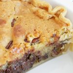 chocolate chip cookie pie - whole pie with slice cut out and view of melted chocolate chips