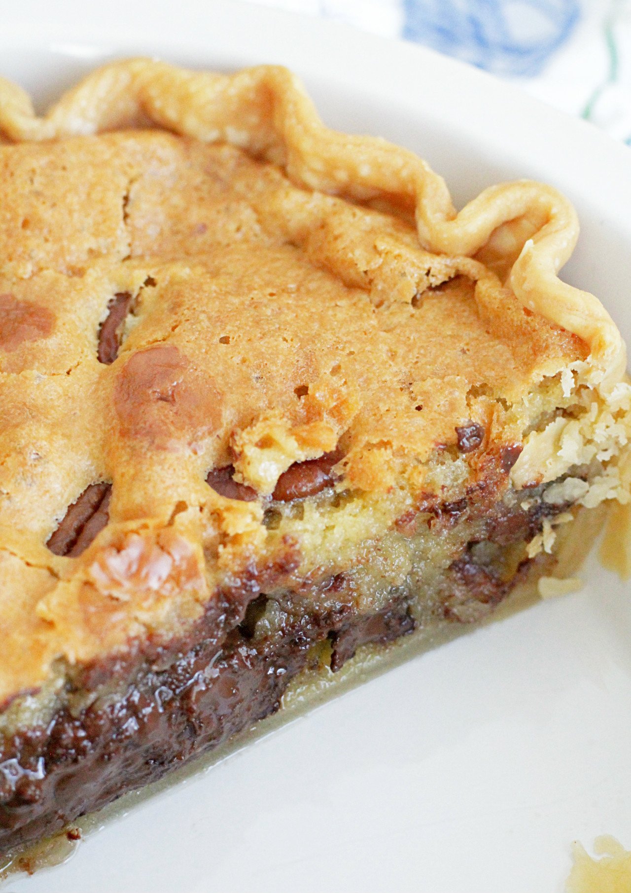 chocolate chip cookie pie - whole pie with slice cut out and view of melted chocolate chips