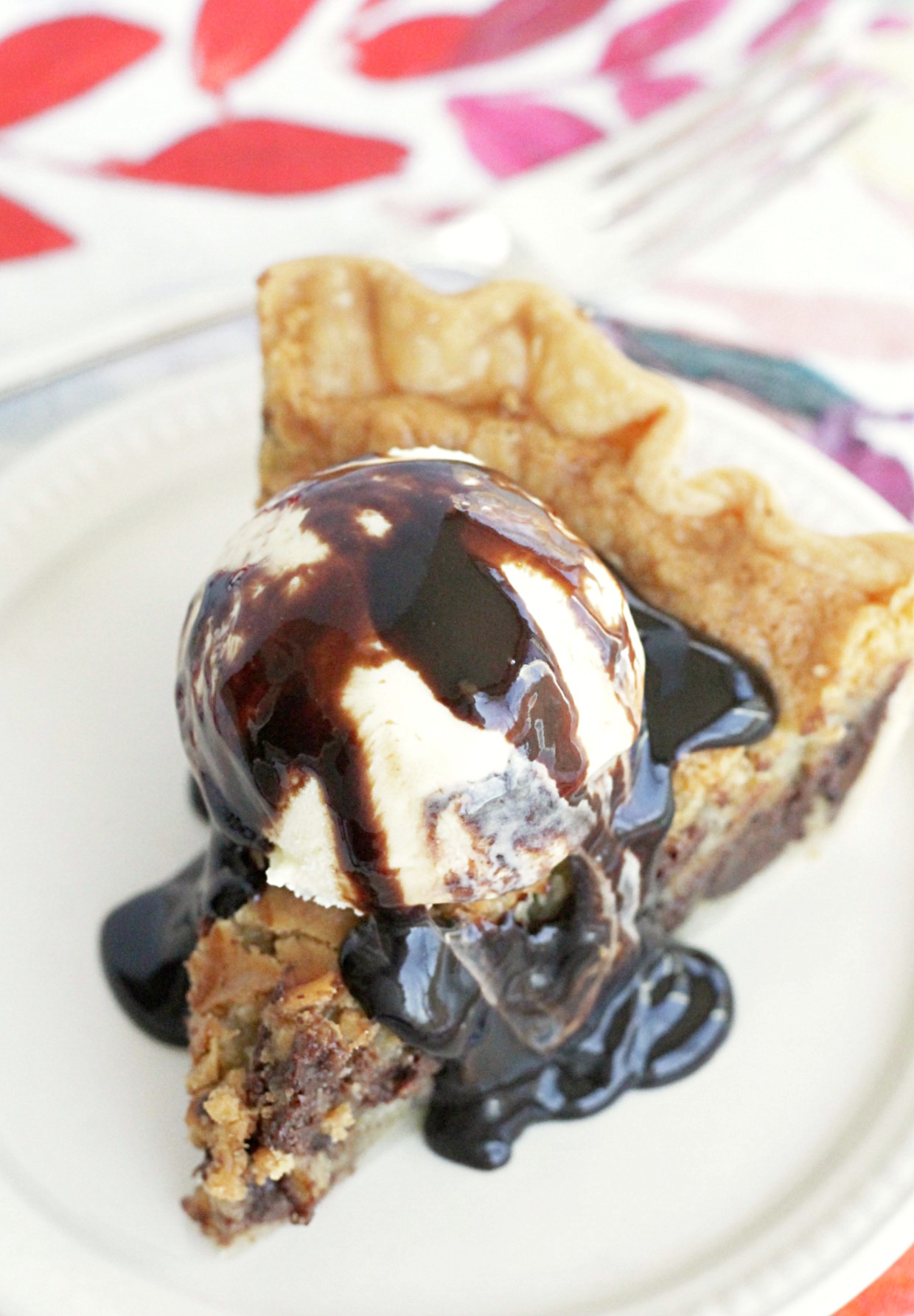 chocolate chip cookie pie slice with ice cream and hot fudge