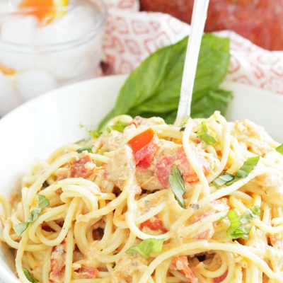 tuscan chicken pasta sauce in bowl with fork