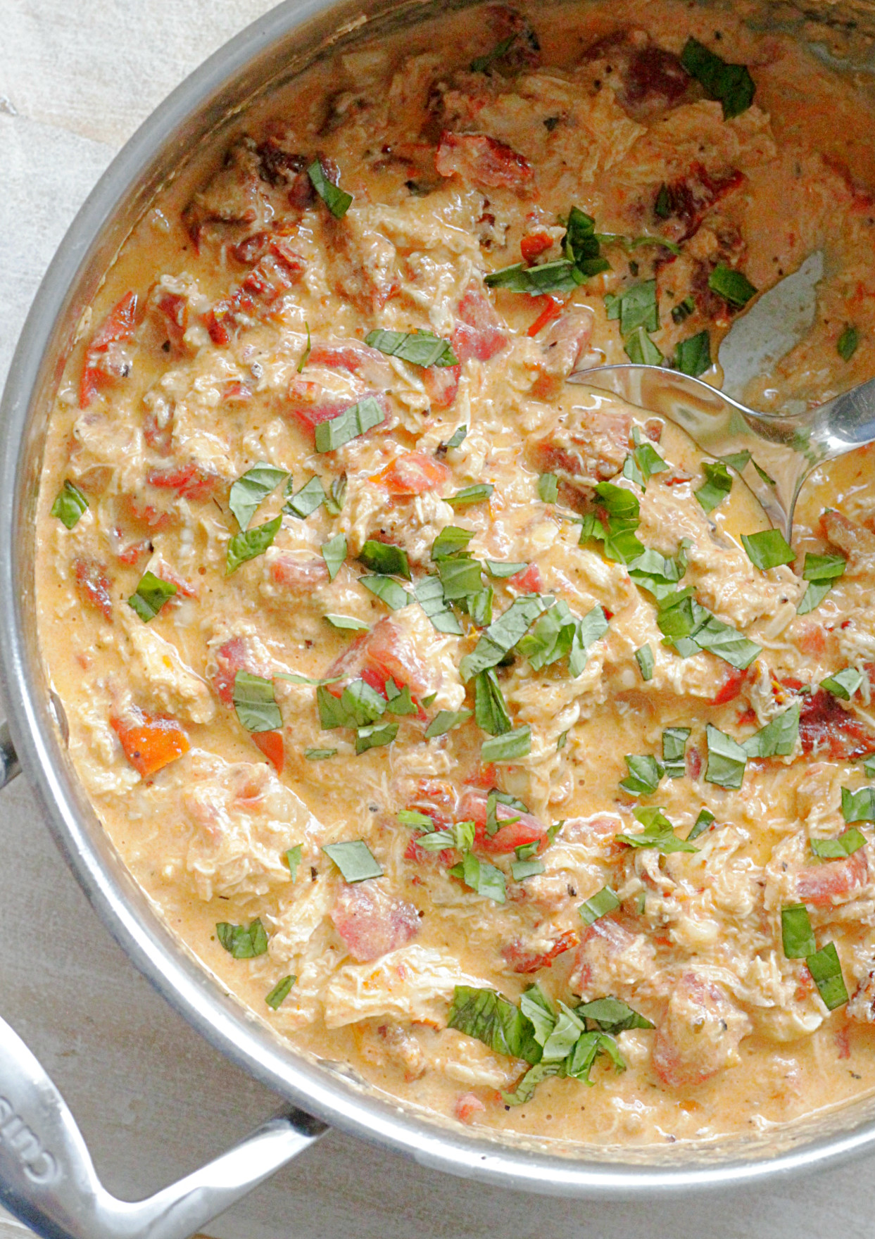 tuscan chicken pasta sauce in sauce pan overhead view