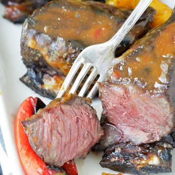 grilled short ribs with asian peanut sauce short ribs sliced in half to show cooked inside