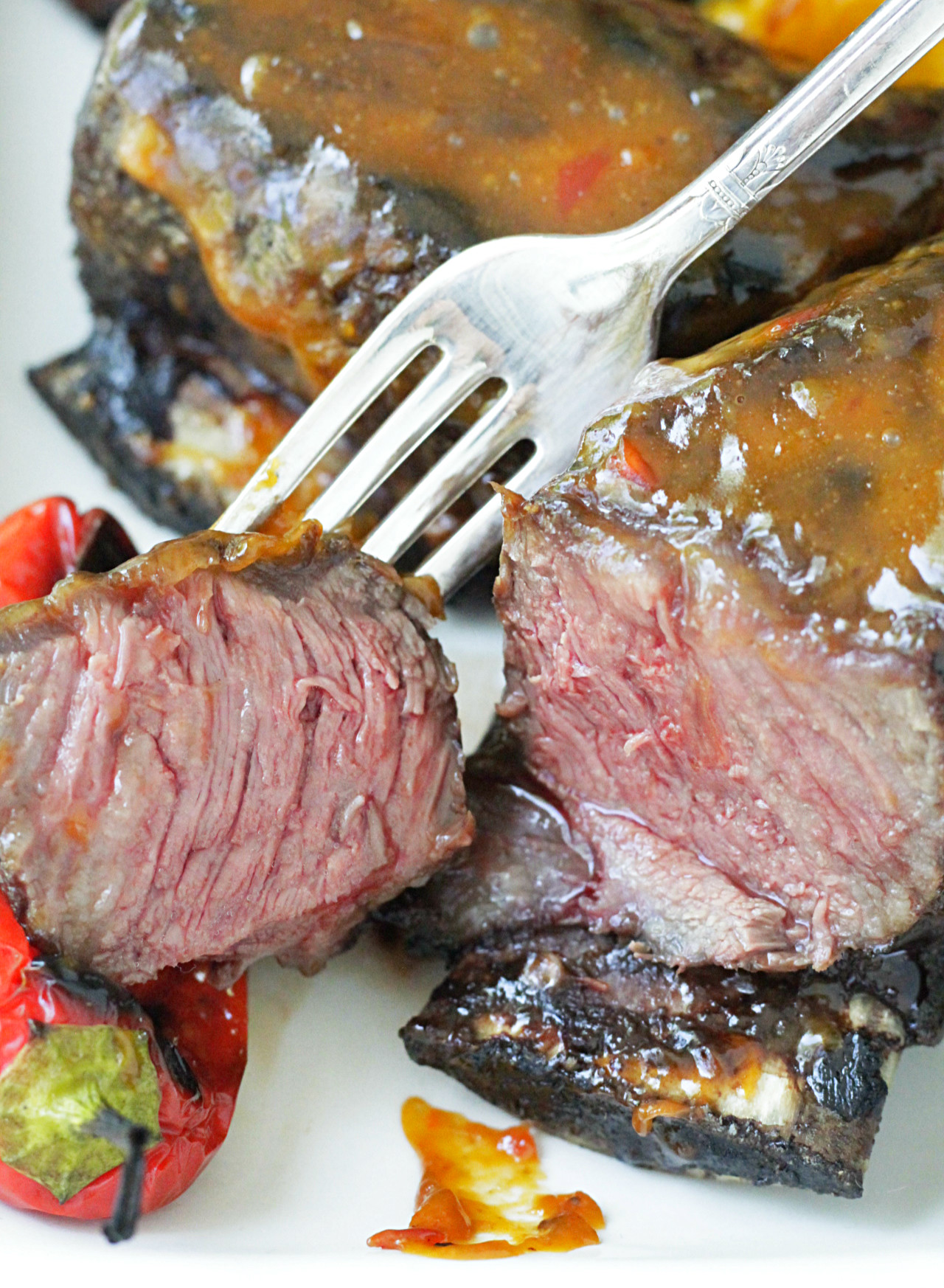 grilled short ribs with asian peanut sauce close up of sliced short rib