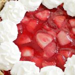 overhead view of whole fresh strawberry cheesecake pie