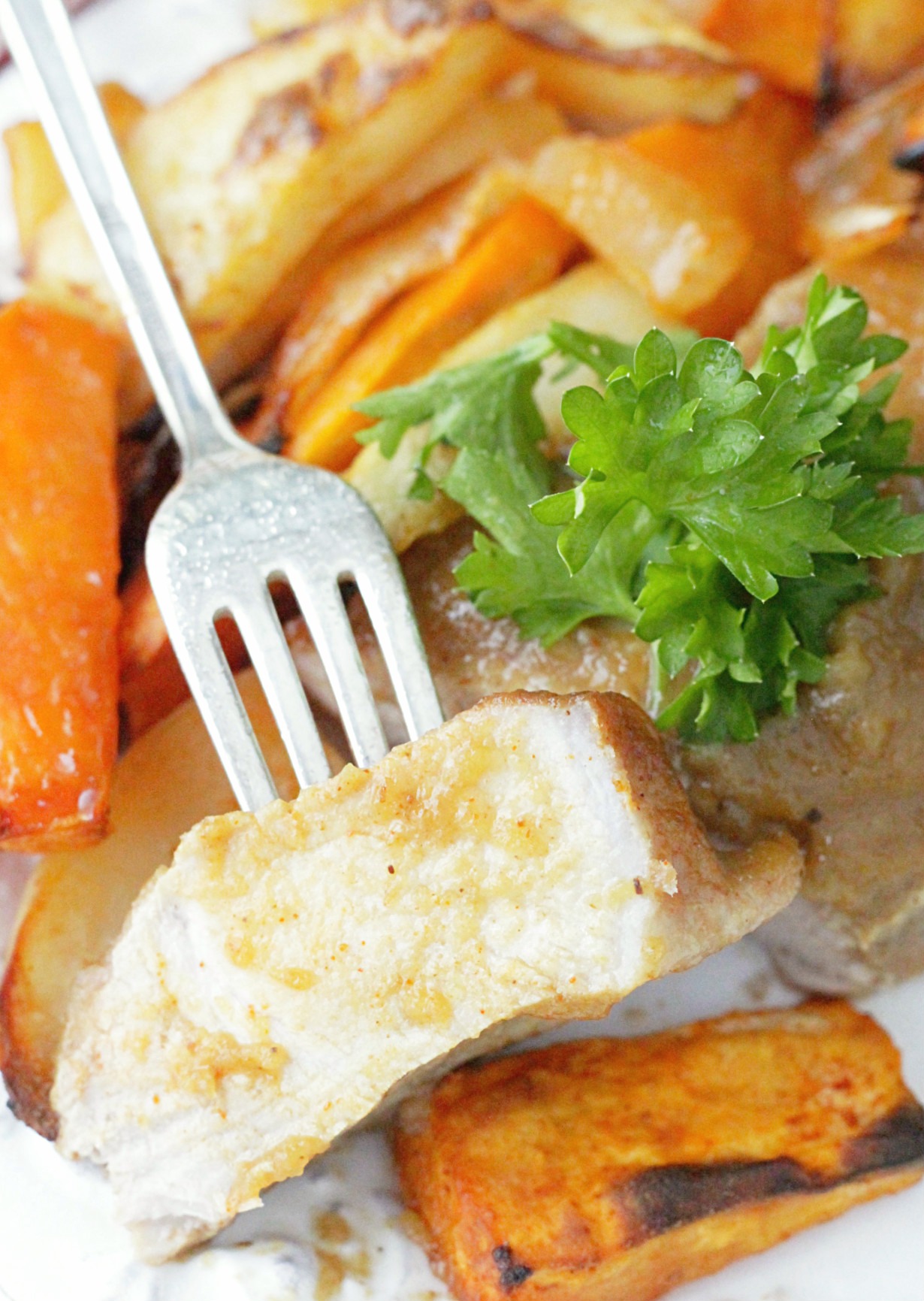 bite of applesauce baked pork chop on a fork