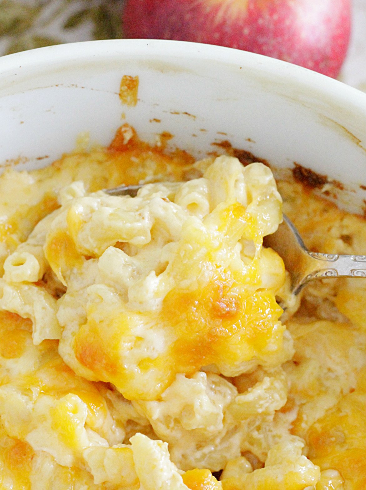 close up of spoon in dish of macaroni and cheese