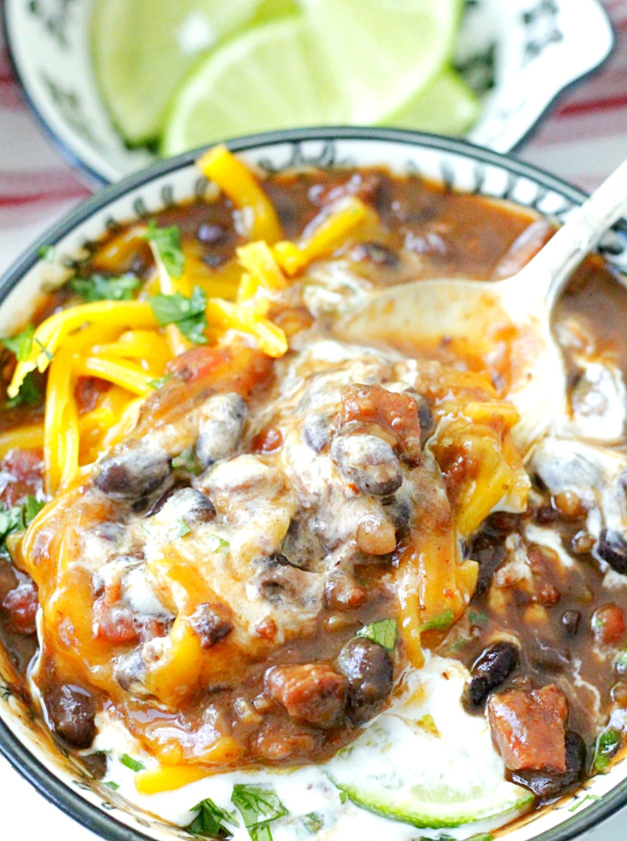 wicked black bean and ghost pepper sausage soup stirred together with sour cream