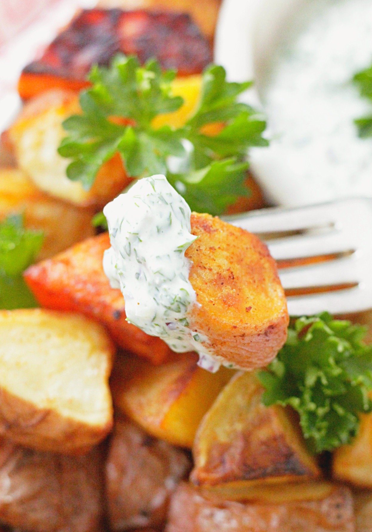 close up view of oven roasted potato on fork