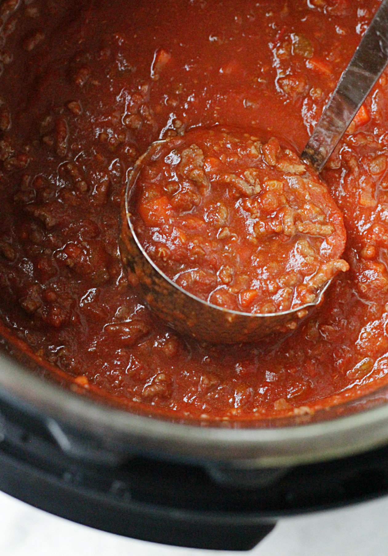 instant pot beef bolognese pasta sauce in ladle