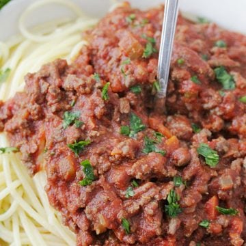 instant pot beef bolognese pasta sauce on top of spaghetti in a bowl