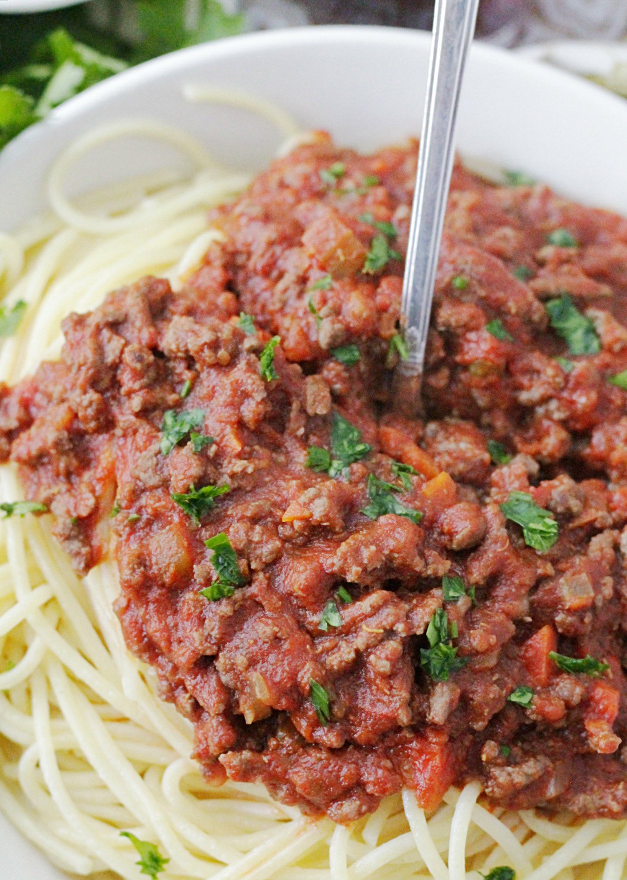 instant pot beef bolognese pasta sauce on top of spaghetti in a bowl