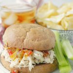 shredded chicken sandwich on plate with celery