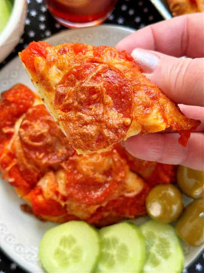 taking a bite of air fryer pizza