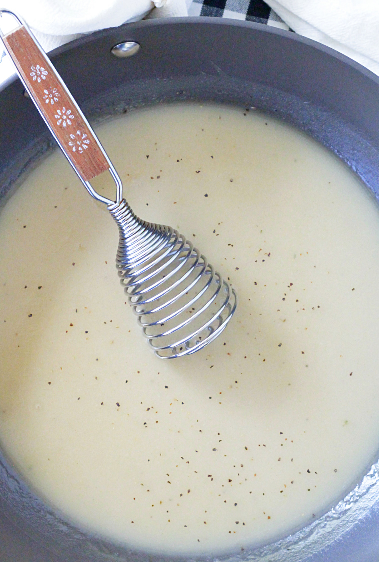 homemade turkey gravy recipe in pan with whisk