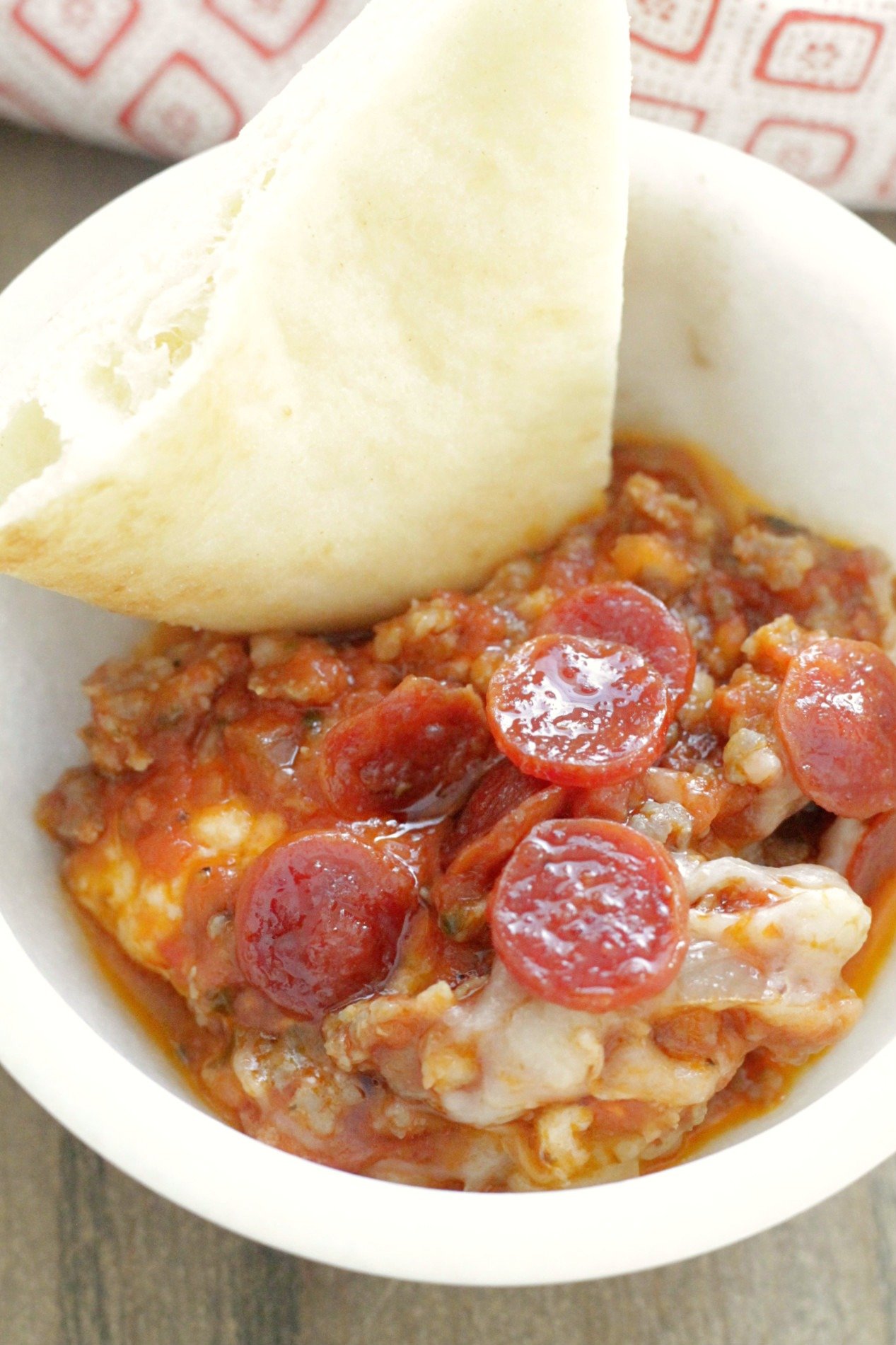 ultimate pizza dip with pita bread in bowl