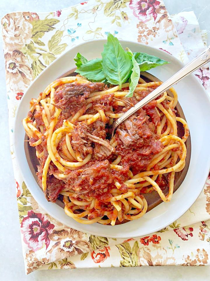 slow cooker short rib sunday gravy overhead shot on plate with fork