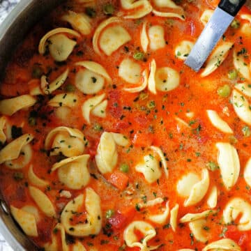 a soup pot full of tortellini soup ready to serve