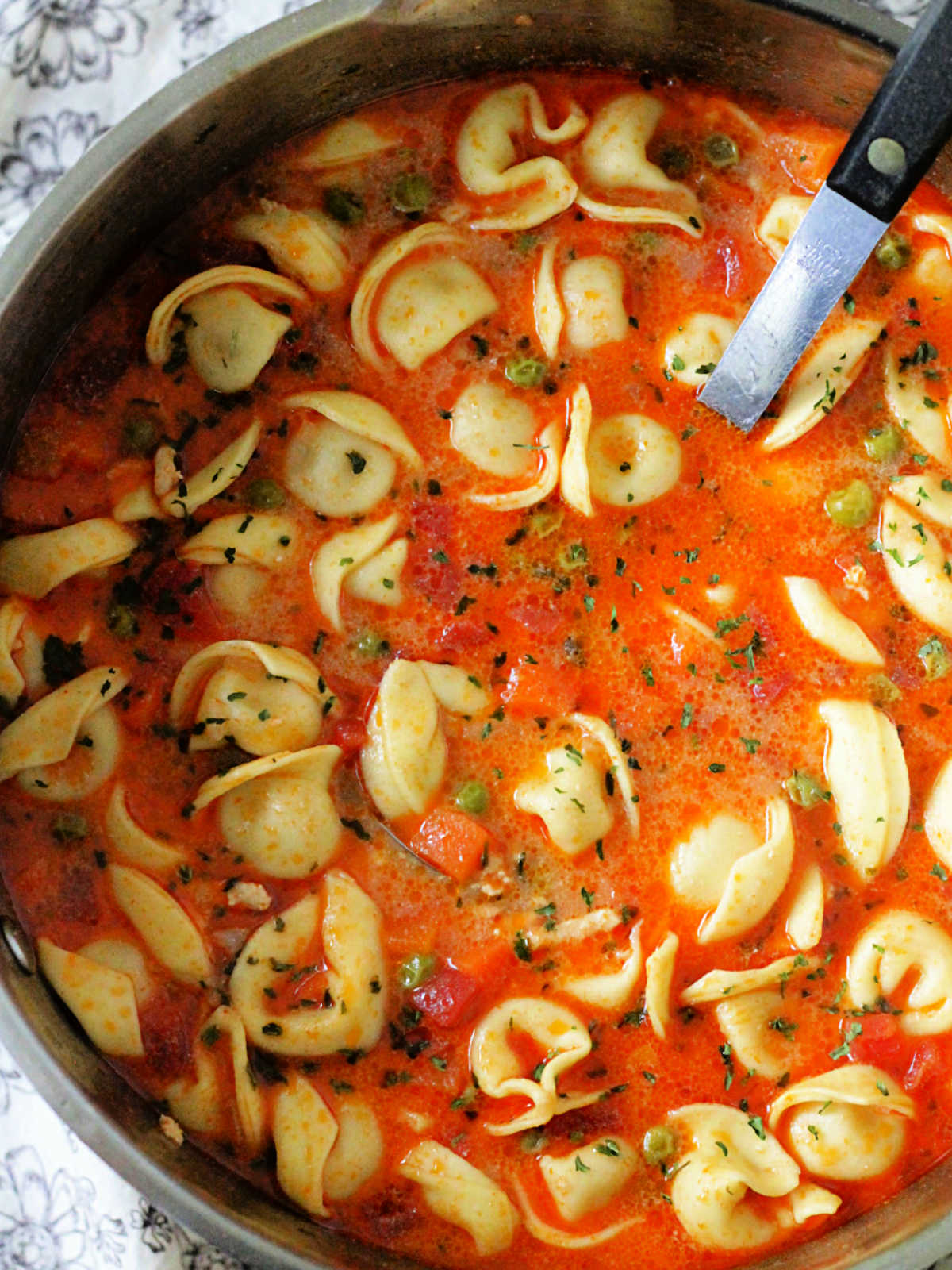 soup pot with ladle ready to serve cheese tortellini soup