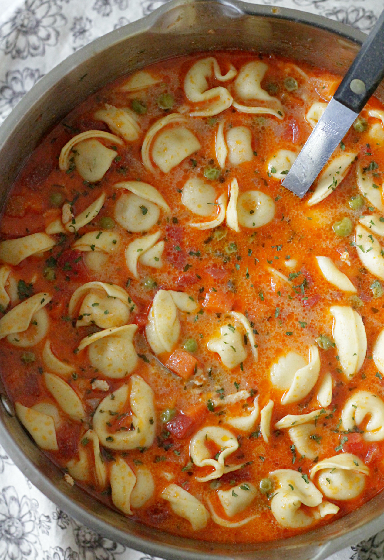 creamy cheese tortellini soup in pot with ladel