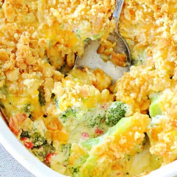 serving a spoonful of broccoli casserole from the baking dish
