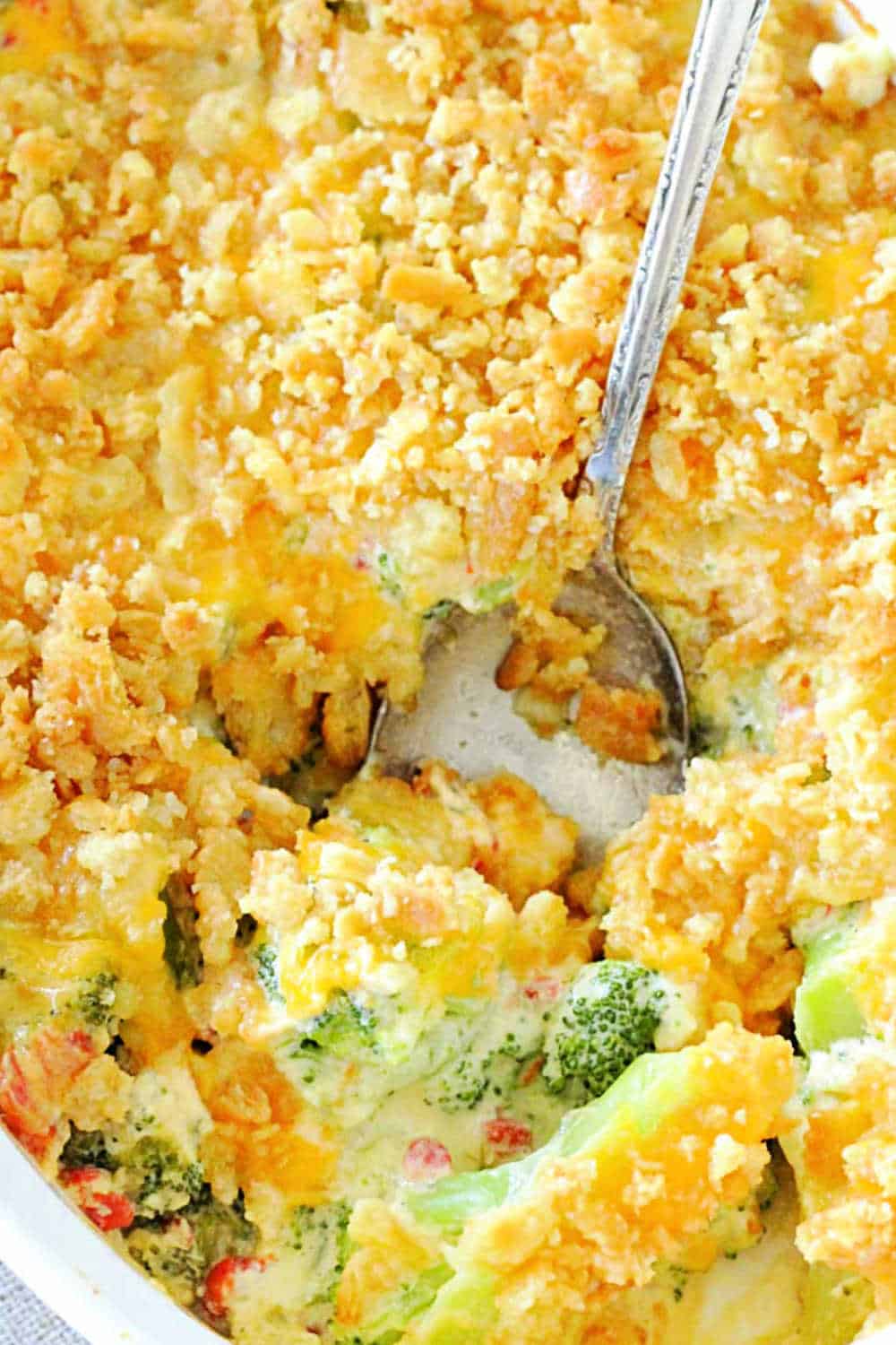 Classic broccoli casserole gets an upgrade with the addition of pimentos, a homemade cheesy sauce and a topping of buttery Ritz crackers. via @foodtasticmom