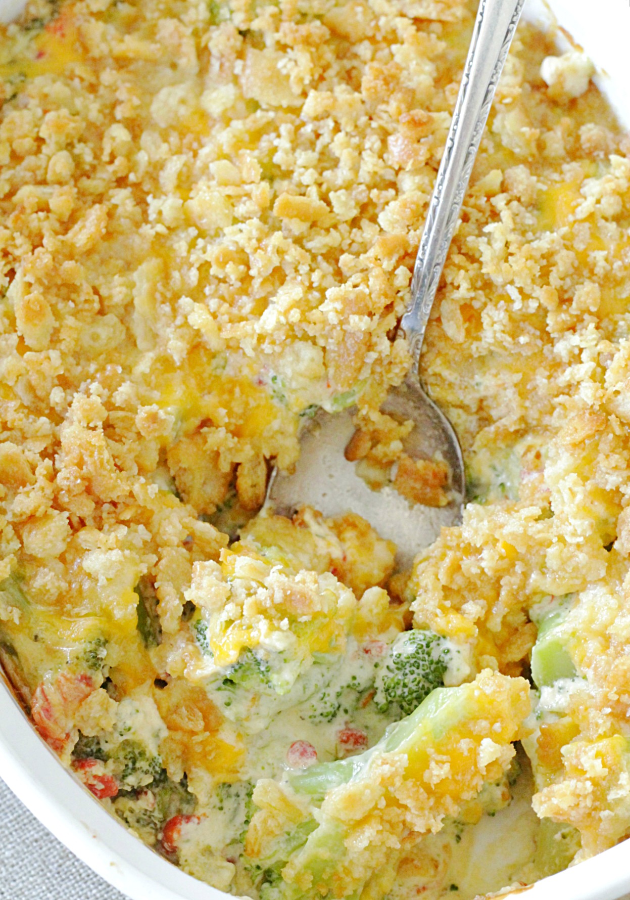 cheesy pimento broccoli casserole in dish with spoon