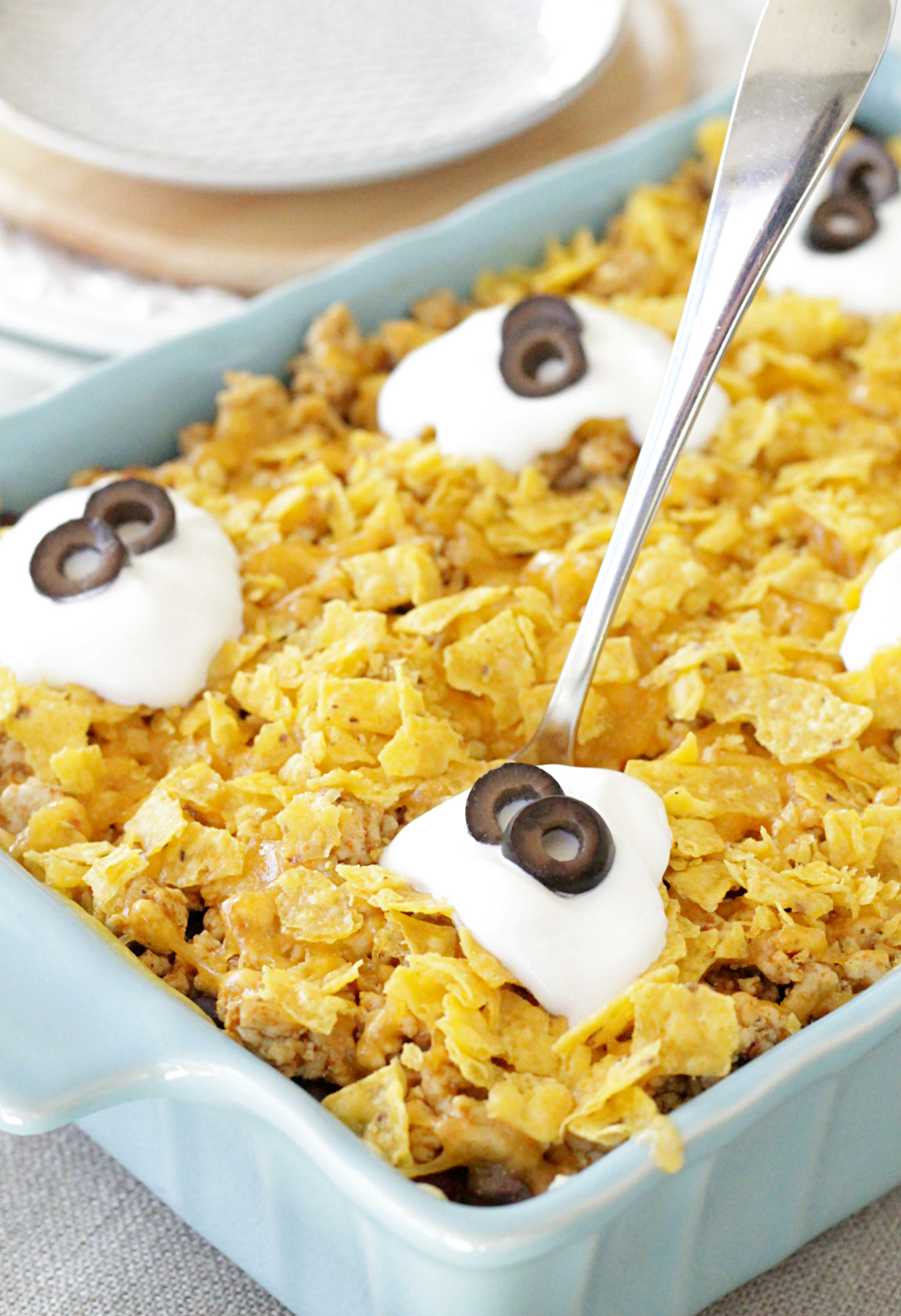 cheesy mexican rice casserole in dish with spoon