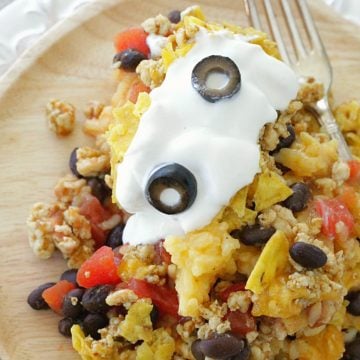 cheesy mexican rice casserole on plate with fork