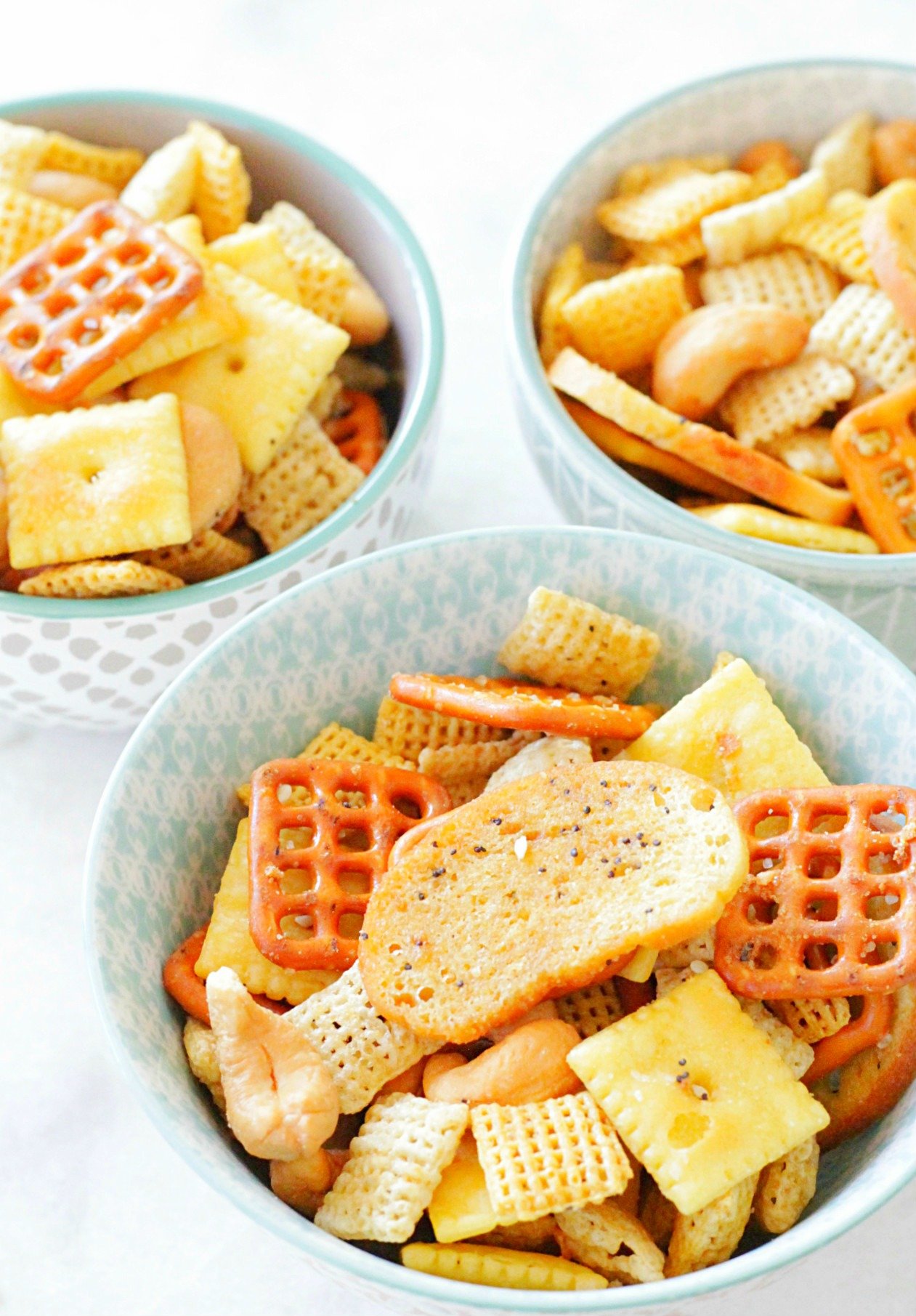 ultimate chex party mix in three small bowls