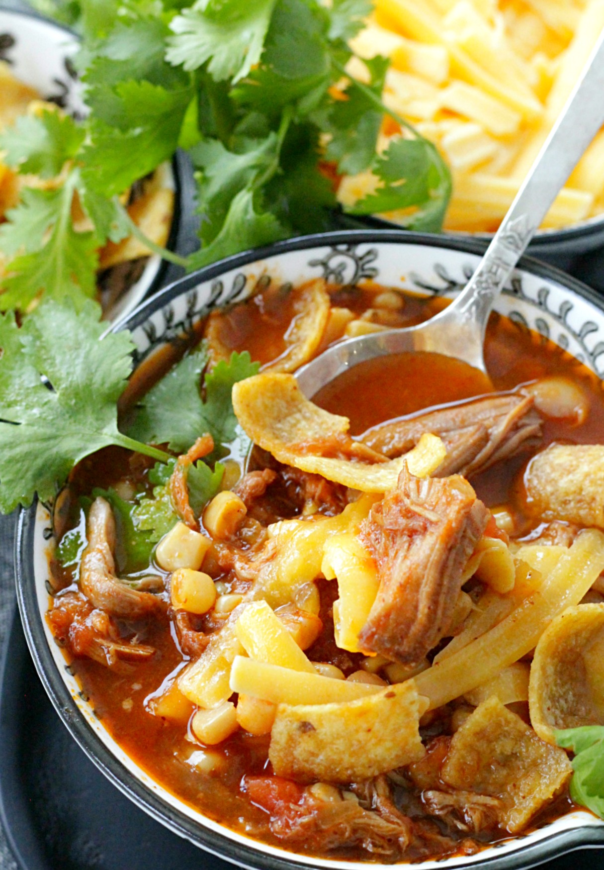 slow pulled pork chili in bowl with spoon