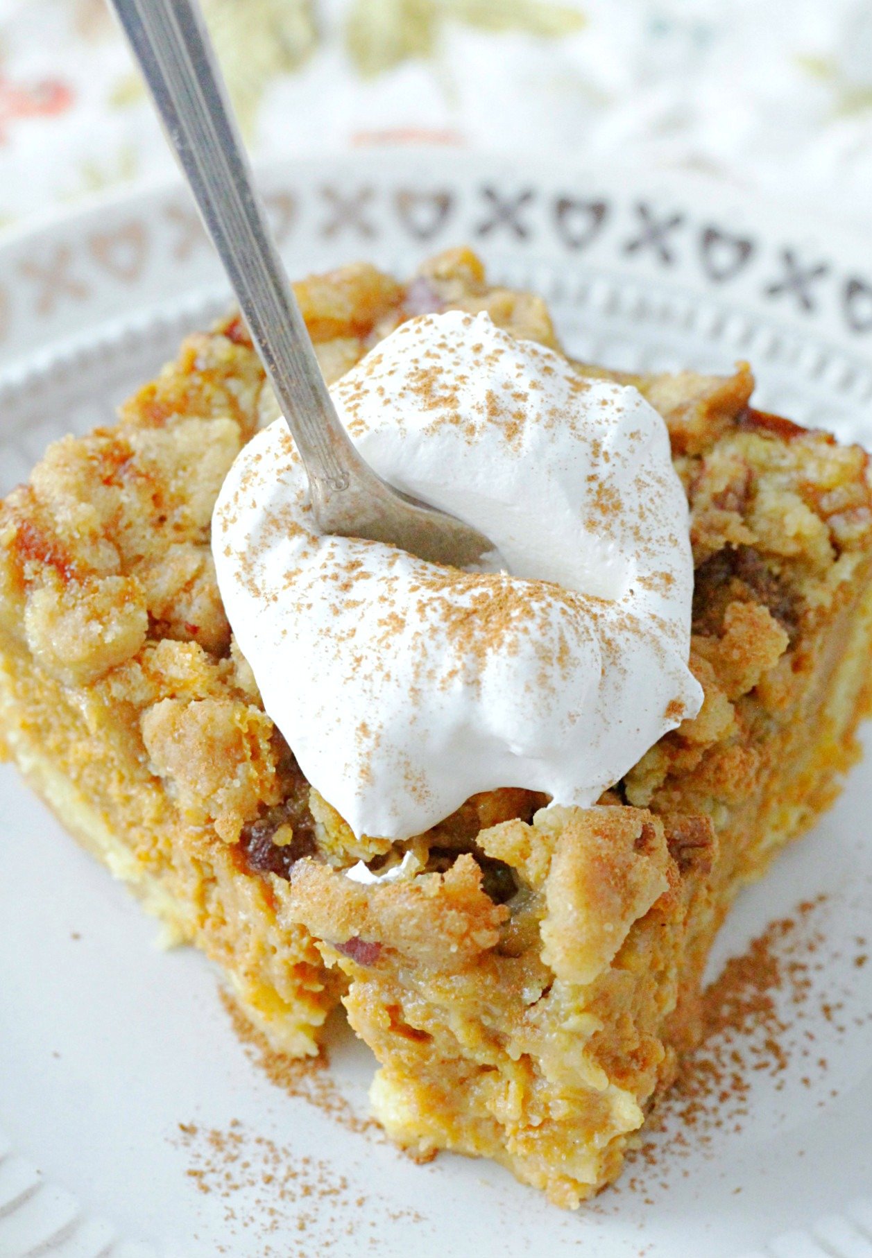 pumpkin pie dump cake topped with whipped cream
