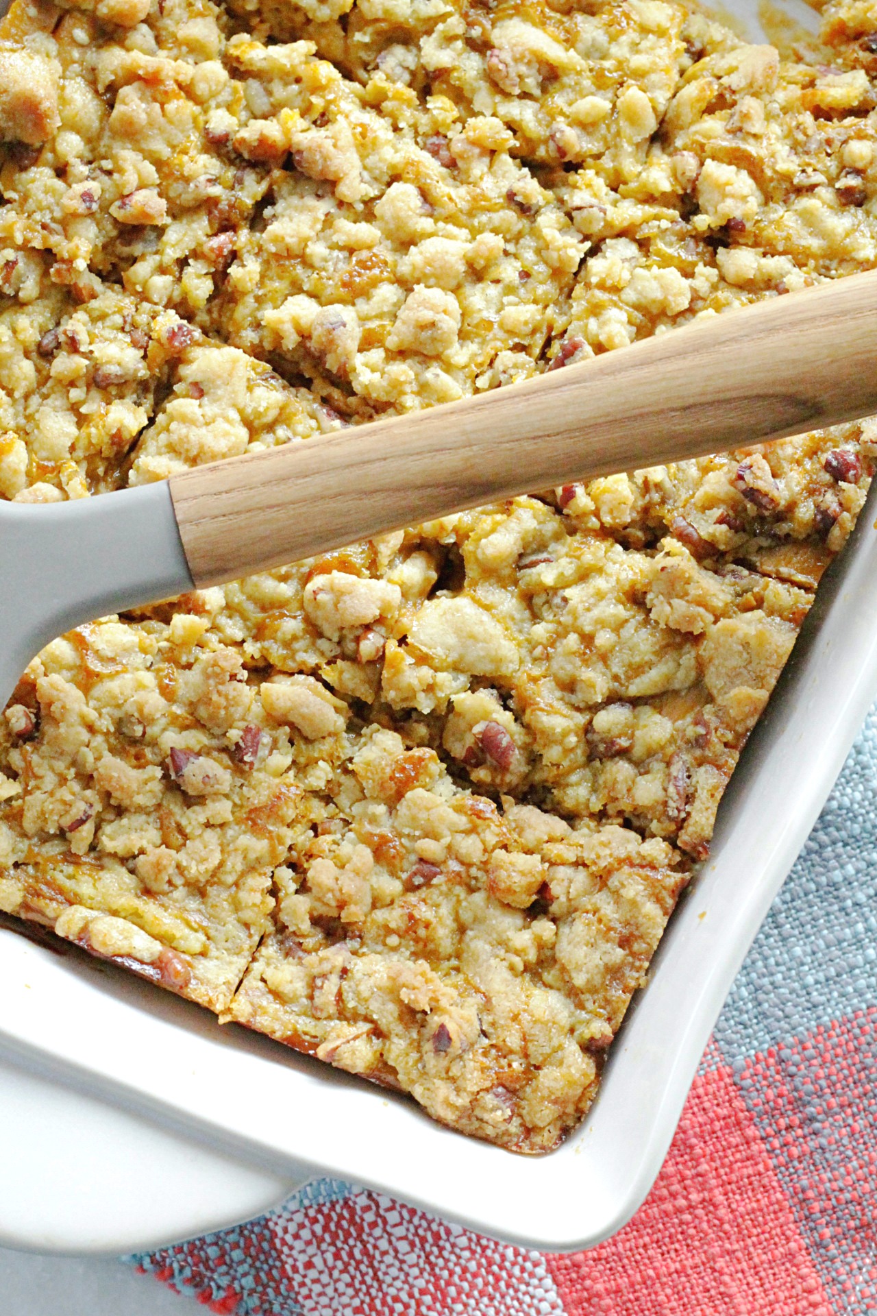 pumpkin pie dump cake in baking dish, sliced