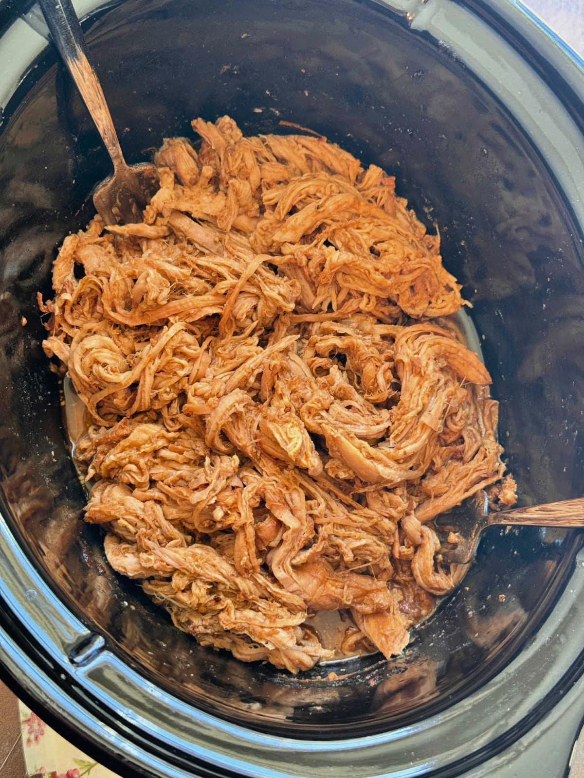 shredded apple butter pork in the slow cooker insert