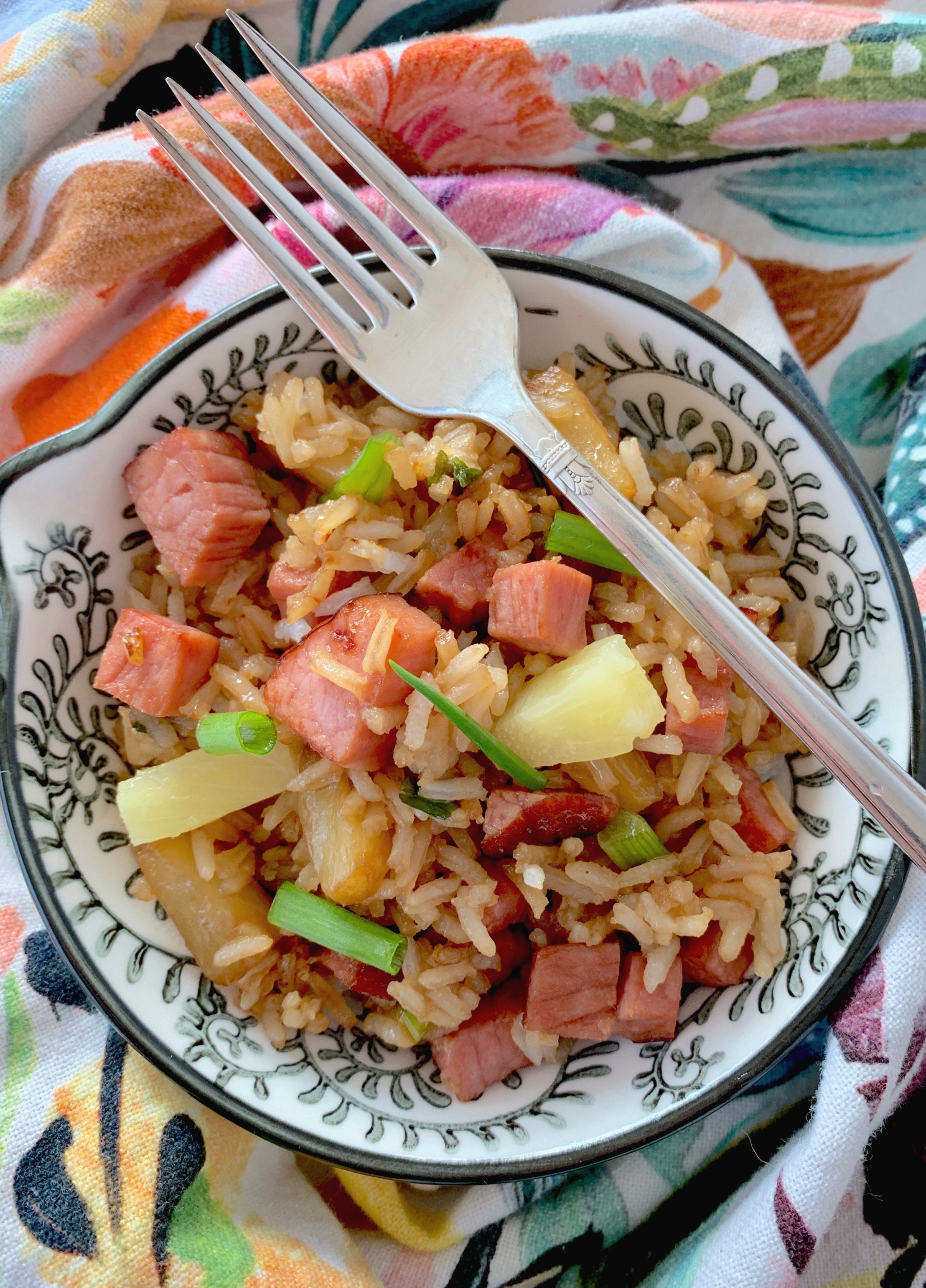 easy fried rice with ham and pineapple in bowl with fork