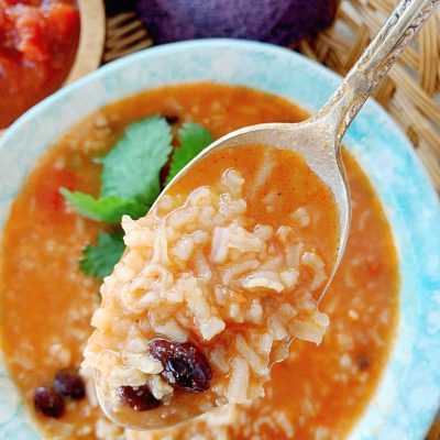 mexican rice and bean soup in a bowl with a spoon