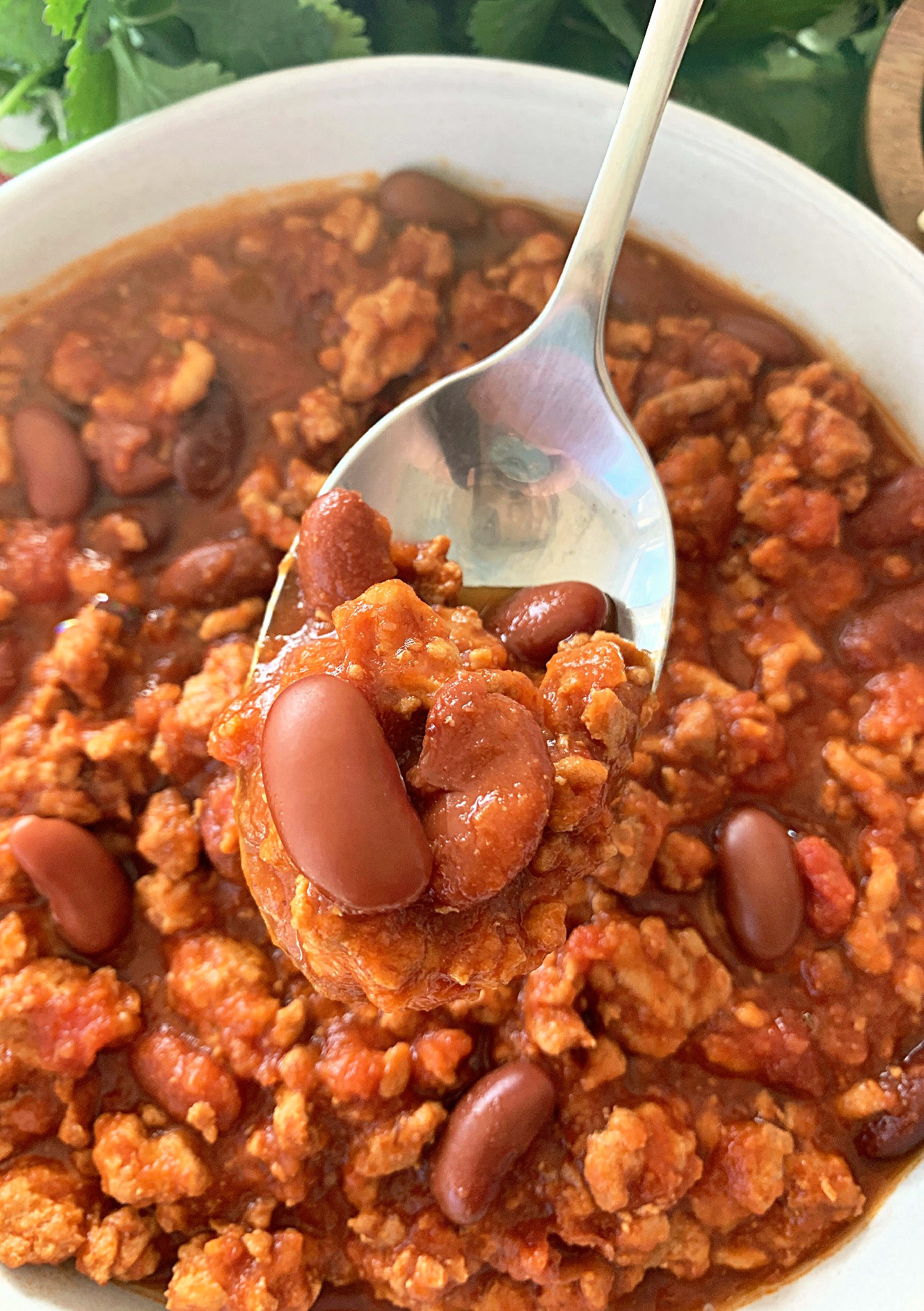 crockpot turkey chili - close up view with chili in spoon