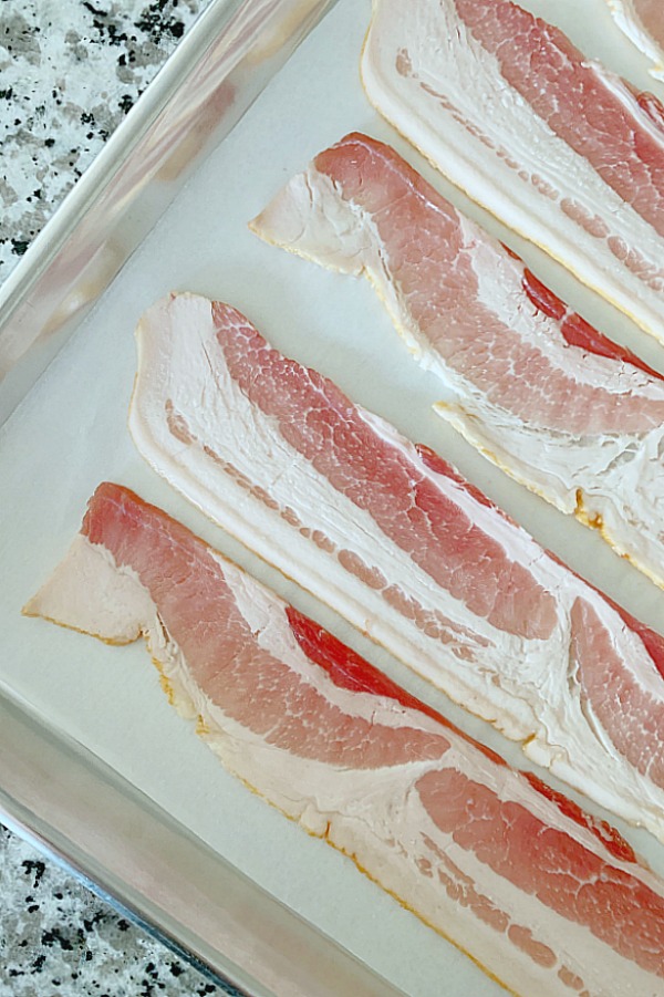 showing how to bake bacon on sheet pan with parchment paper