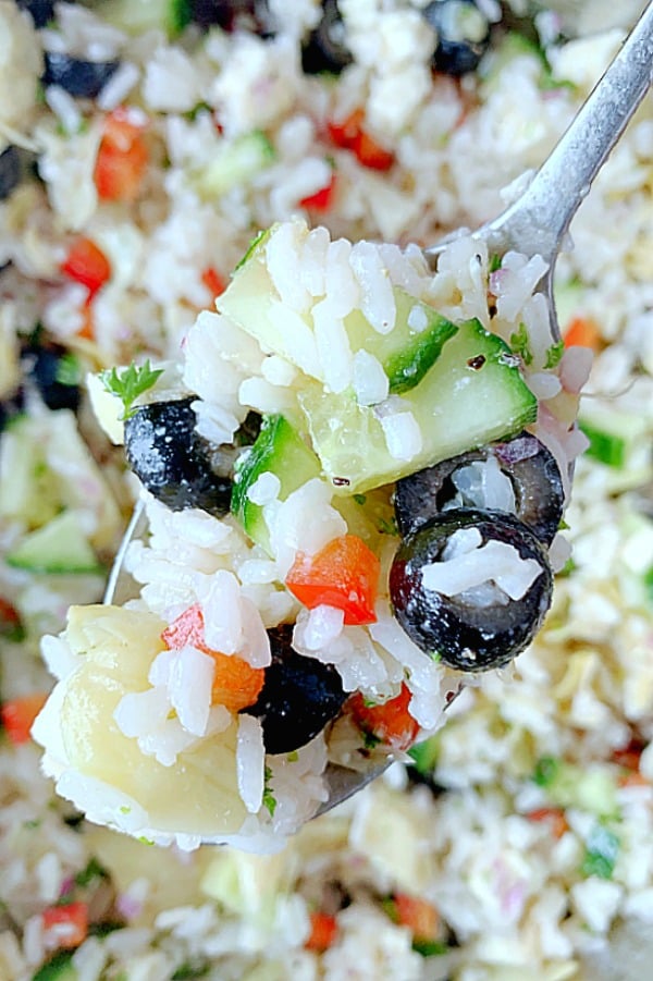 close up of spoon full of greek rice salad