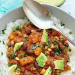 overhead view of vegetarian chili in bowl with spoon