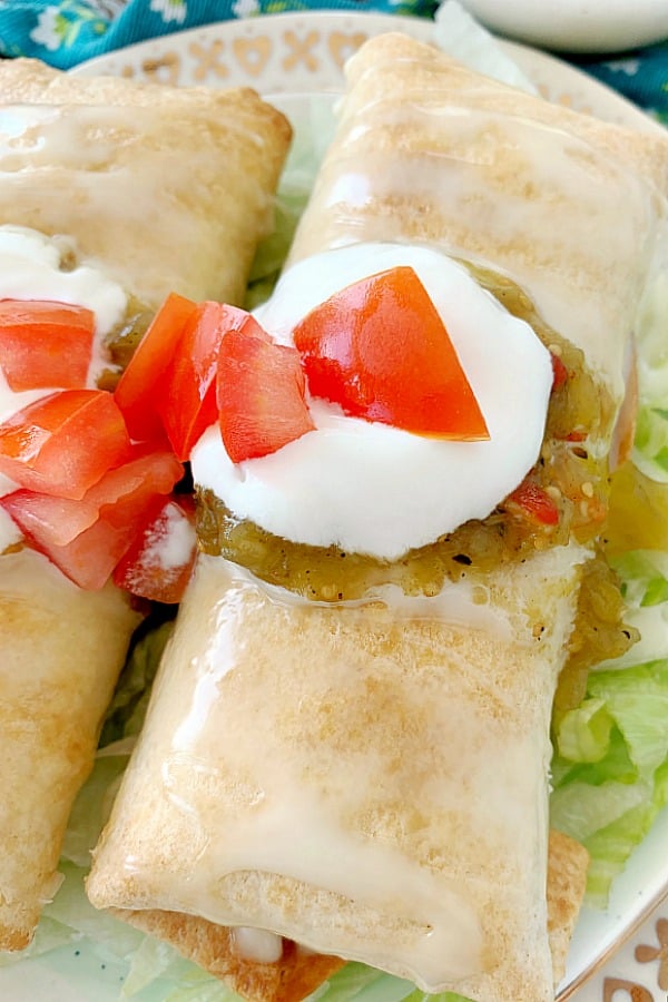 air fyer chicken chimichangas topped with cheese sauce