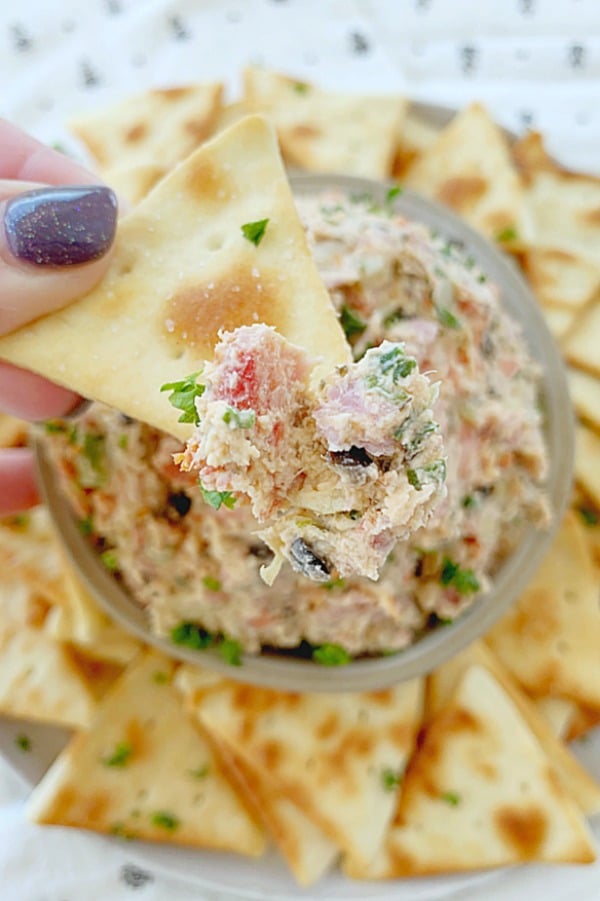 italian cream cheese with chip dipped into it