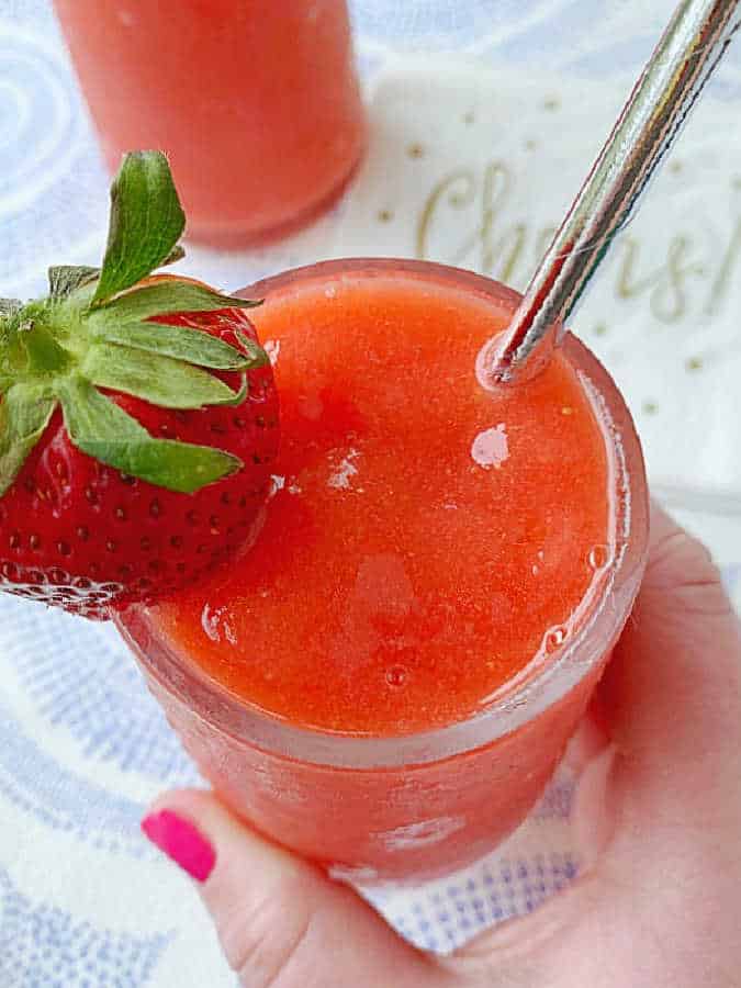 getting ready to take a sip of a sweet frozen strawberry daiquiri