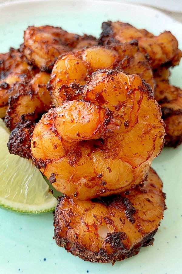 air fried shrimp on a plate with lime wedge